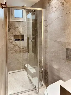 a shower with a glass door in a bathroom at Ermou 18 Central Cozy Apartment in Athens