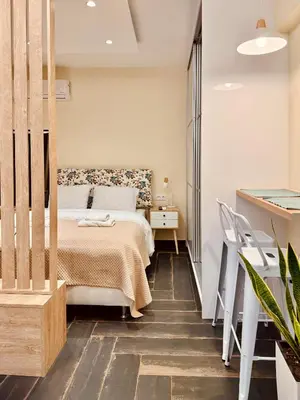 a bedroom with a bed and a table and chairs at Ermou 18 Central Cozy Apartment in Athens