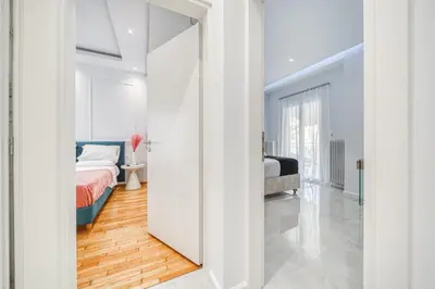 a bedroom with a bed and a mirror at Infinity penthouse in Koukaki in Athens