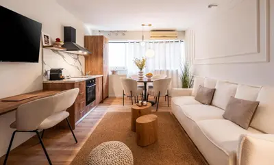 a living room with a couch and a table at ATELIER 33 , Acropolis Apartments in Athens