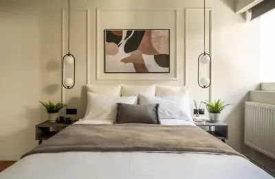 a bedroom with a large white bed with two lamps at ATELIER 33 , Acropolis Apartments in Athens