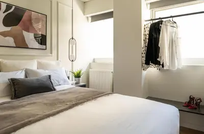 a bedroom with a white bed and a window at ATELIER 33 , Acropolis Apartments in Athens