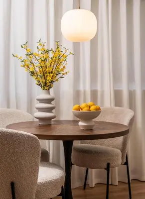 a table with a vase and a bowl of oranges on it at ATELIER 33 , Acropolis Apartments in Athens