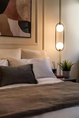 a bedroom with a bed and a potted plant at ATELIER 33 , Acropolis Apartments in Athens