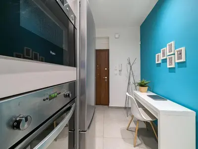 a kitchen with a refrigerator and a table and a desk at Modern&Stylish 1BD apt next metro and Acropolis in Athens
