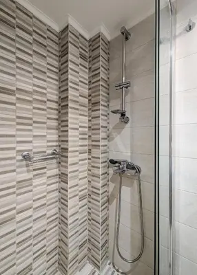 a shower with a glass door in a bathroom at Modern&Stylish 1BD apt next metro and Acropolis in Athens
