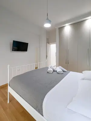 a bedroom with a large white bed with two pillows at Modern&Stylish 1BD apt next metro and Acropolis in Athens