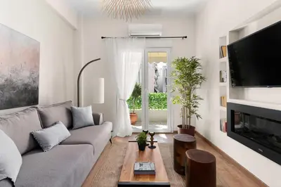 a living room with a couch and a tv at Elegant&Cozy 2BD Historic Center next to metro in Athens