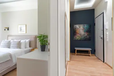 a bedroom with a white bed and a blue wall at Elegant&Cozy 2BD Historic Center next to metro in Athens