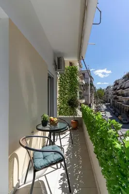 a patio with a table and chairs on a balcony at Elegant&Cozy 2BD Historic Center next to metro in Athens