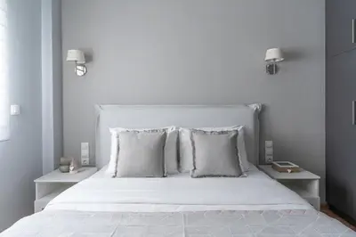 a bedroom with a white bed with two pillows at Elegant&Cozy 2BD Historic Center next to metro in Athens