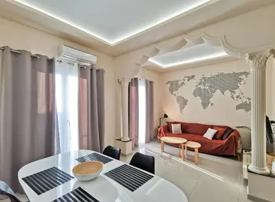 a living room with a table and a world map on the wall at Contemporary 2BD apt with terrace Historic center in Athens