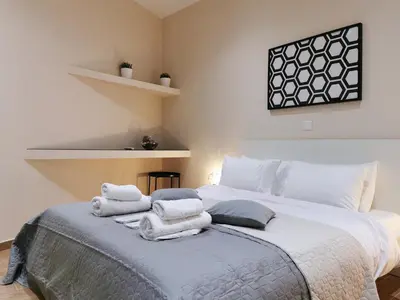 a bedroom with a large bed with towels on it at Contemporary 2BD apt with terrace Historic center in Athens