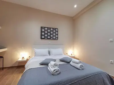 a bedroom with a large bed with towels on it at Contemporary 2BD apt with terrace Historic center in Athens