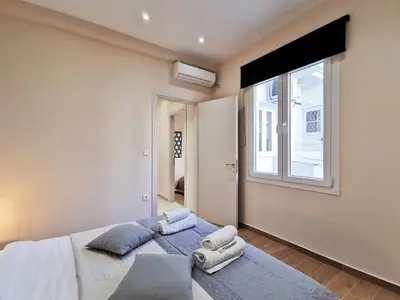 a bedroom with a large bed with towels on it at Contemporary 2BD apt with terrace Historic center in Athens