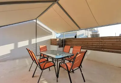 a glass table and chairs on a balcony at Contemporary 2BD apt with terrace Historic center in Athens