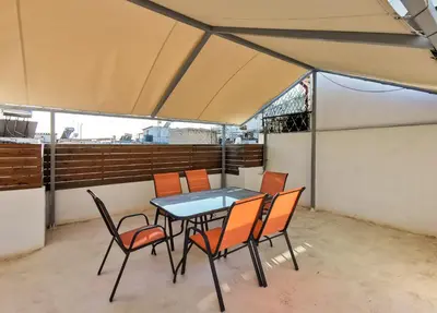 a table and chairs on a balcony at Contemporary 2BD apt with terrace Historic center in Athens