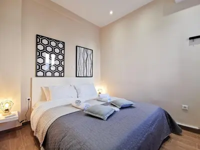 a bedroom with a large bed with two towels on it at Contemporary 2BD apt with terrace Historic center in Athens
