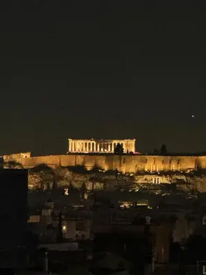 a building on top of a hill at night at M&H and their friends 2 in Athens