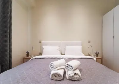 a bedroom with a bed with towels on it at Modern&Sunny, 1BD, next to metro in Athens