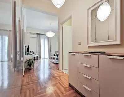 a kitchen with wooden floors and white walls at Modern&Sunny, 1BD, next to metro in Athens