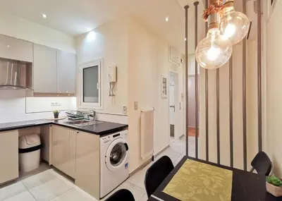 a kitchen with a washer and a washing machine at Modern&Sunny, 1BD, next to metro in Athens