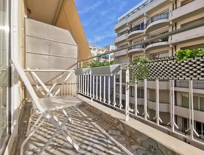 a white chair sitting on the balcony of a building at Modern&Sunny, 1BD, next to metro in Athens