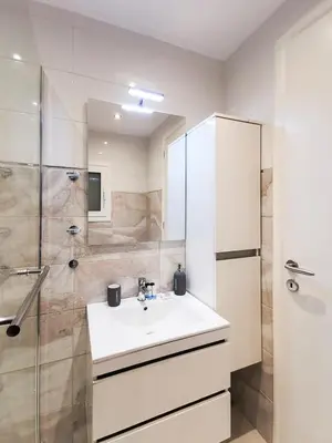 a bathroom with a sink and a shower at Modern&Sunny, 1BD, next to metro in Athens