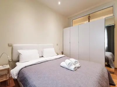 a bedroom with a large bed with towels on it at Modern&Sunny, 1BD, next to metro in Athens
