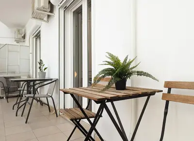 a table with a potted plant on it in a room at Modern&Quiet 2BD apt on a pedestrian in Athens