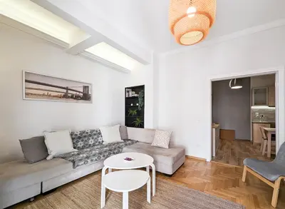 a living room with a couch and a table at Modern&Quiet 2BD apt on a pedestrian in Athens