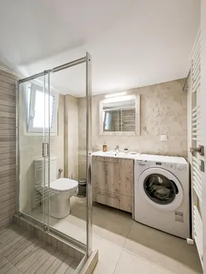 a bathroom with a washing machine and a toilet at Modern&Quiet 2BD apt on a pedestrian in Athens