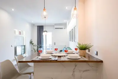 a dining room with a table and chairs at Modern 2BD very spacious apt next to metro station in Athens