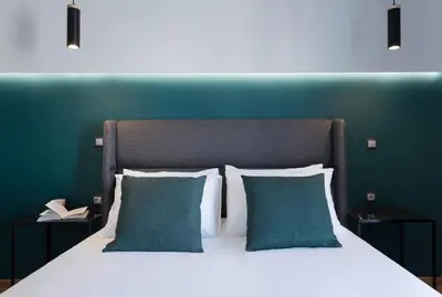 a bedroom with a large bed with two blue walls at Modern 2BD very spacious apt next to metro station in Athens