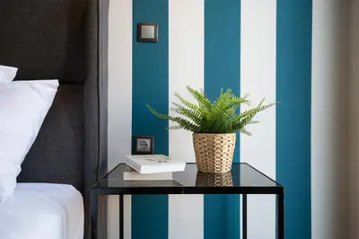 a plant on a glass table next to a bed at Modern 2BD very spacious apt next to metro station in Athens