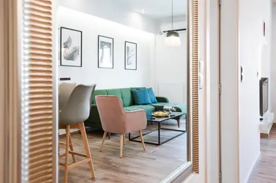 a living room with a green couch and a table at Modern 2BD very spacious apt next to metro station in Athens