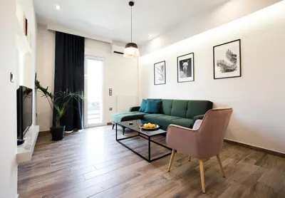 a living room with a green couch and a table at Modern 2BD very spacious apt next to metro station in Athens