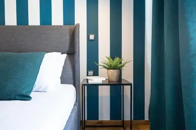 a bedroom with a blue and white striped wall at Modern 2BD very spacious apt next to metro station in Athens