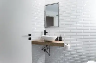 a white bathroom with a sink and a mirror at Modern 2BD very spacious apt next to metro station in Athens