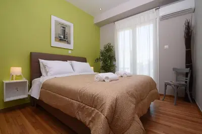a bedroom with a large bed with towels on it at Iconic 2BD apt next to Historic center and metro in Athens