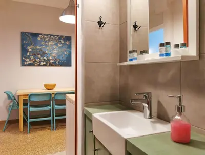 a small kitchen with a sink and a table at Hidden Gem next to Acropolis&metro in Athens