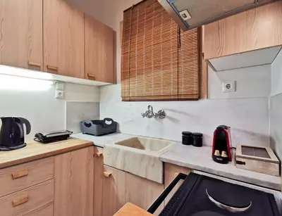 a small kitchen with a sink and a stove at Hidden Gem next to Acropolis&metro in Athens