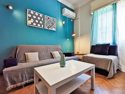 a living room with a couch and a table at Hidden Gem next to Acropolis&metro in Athens