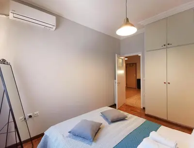 a bedroom with a bed with two pillows on it at Hidden Gem next to Acropolis&metro in Athens