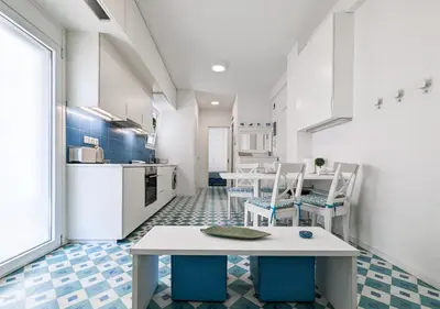 a kitchen with a table and chairs in a room at Greek island styled 1BD apt 500m from the sea in Athens