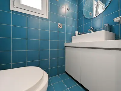 a blue bathroom with a toilet and a sink at Greek island styled 1BD apt 500m from the sea in Athens