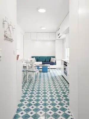 a kitchen and living room with a blue and white floor at Greek island styled 1BD apt 500m from the sea in Athens