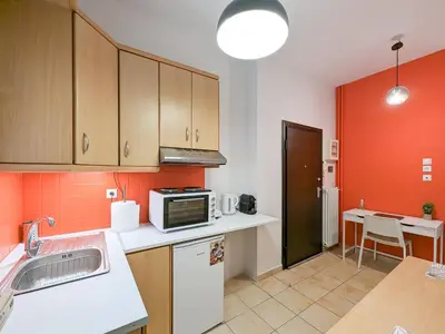 a kitchen with a sink and a microwave at Cozy 1BD apt next to Kallimarmaro Stadium in Athens