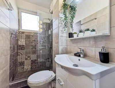 a bathroom with a white sink and a toilet at Charming 2BD apt next to metro station in Athens