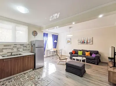 a kitchen and a living room with a couch at Charming 2BD apt next to metro station in Athens